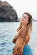 © Daniel - One young blonde and beautiful young woman looking and enjoying summer days in vacation holiday having fun in catamaran boat sailing in the water of sea.