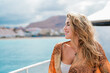 © Daniel - One young blonde and beautiful young woman looking and enjoying summer days in vacation holiday having fun in catamaran boat sailing in the water of sea.