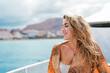 © Daniel - One young blonde and beautiful young woman looking and enjoying summer days in vacation holiday having fun in catamaran boat sailing in the water of sea.