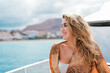 © Daniel - One young blonde and beautiful young woman looking and enjoying summer days in vacation holiday having fun in catamaran boat sailing in the water of sea.