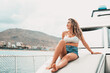 © Daniel - One young attractive girl enjoying summer days relaxed on catamaran in the ocean with turquoise water. Vacation lifestyle concept