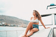 © Daniel - One young attractive girl enjoying summer days relaxed on catamaran in the ocean with turquoise water. Vacation lifestyle concept