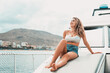 © Daniel - One young attractive girl enjoying summer days relaxed on catamaran in the ocean with turquoise water. Vacation lifestyle concept