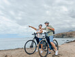 © Daniel - Two happy old mature people enjoying and riding bikes together to be fit and healthy outdoors. Active seniors having fun training in nature. Portrait of one old man smiling in a bike trip with wife