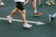 © Duet Postscriptum/Stocksy - Motion blur shot of runners with arrow on the ground