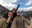 © Desde El Sur/Stocksy - UGC Group Selfie in Ushuaia with Snowy Mountain View