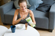 © mahalo studio/Stocksy - woman preparing matcha tea in her living room