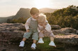 © Ezequiel Giménez/Stocksy - Big brother kissing baby sister at sunset