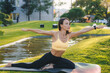 © Strelciuc - A woman is practicing yoga in nature, embracing a beautiful sunrise session outdoors