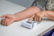 © Olena Smyrnova/Stocksy - Elderly woman measures her blood pressure on one's own