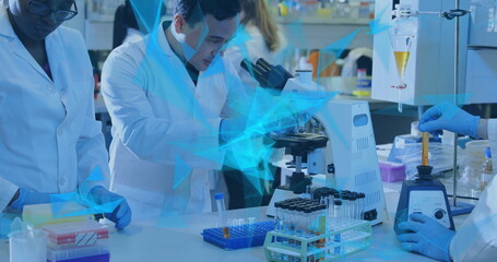  - Image of glowing light trails over diverse scientists in laboratory