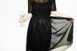 © Colour Laboratory/Stocksy - Person with balck fashion festive party dress holding a cocktail glass