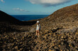 © Adrian Rodd/Stocksy - Hiker uses a smartphone to take pictures of the seascape from a slope