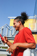 © Artem Podrez/Stocksy - Man using phone under bright blue sky
