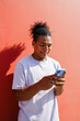 © Artem Podrez/Stocksy - Young Man Using App on Smartphone Outdoors