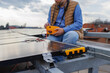 © Jovo Jovanovic/Stocksy - Male engineer using equipment on solar panel