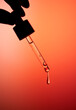 © Tatyana Lavrova/Stocksy - Hand holding dropper bottle with anti aging face serum.