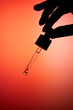 © Tatyana Lavrova/Stocksy - Hand holding dropper bottle with anti aging face serum.