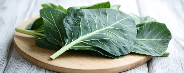 Poster - Fresh collard greens resting on wooden cutting board, ready for cooking