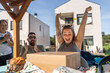 © Alvaro Lavin/Stocksy - Excited woman celebrating while unpacking cardboard box