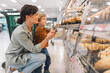 © Santi Nuñez/Stocksy - Mother and son selecting fresh bread from the bakery section