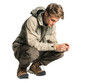 Man is kneeling down and looking at something