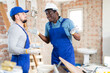 © JackF - Portrait of two confused construction workers emotionally gesturing, having problems at indoors building construction site