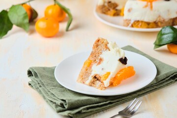 Wall Mural - Jelly cake with a creamy part, spiced cupcake and tangerine on a white cake stand on a light concrete background. Dessert recipes