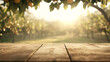 © Thamrong - An empty wooden table with a slightly worn surface is positioned in the foreground. Behind it, the blurred view captures a sunny orchard filled with fruit trees and vibrant foliage, evoking the