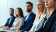 © Wonderful Studio - A focused group of professionals seated in a modern office setting, attentively engaged in a discussion or presentation.