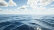 © Azis Stock - Calm ocean surface with blue water and bright sky, few clouds.