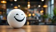 © HC Designer - A white smiling ball on the table in the office interior, promoting a positive work environment and inspiring corporate culture. Significantly, positivity, passion and dedication in the workplace