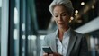 © Alexander Chaykin - Businesswoman Using Phone in Office Setting