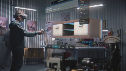 Fototapete - Modern workshop: Professional craftsman or designer wearing AR headset assembles shelf in virtual space using app with AI user interface. 3D animation of holographic furniture. Augmented reality.
