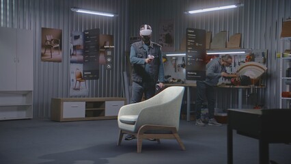Fototapete - Modern workshop: Professional craftsman or designer wearing AR headset assembles chair in virtual space using app with AI user interface. 3D visualization of holographic furniture. Augmented reality.