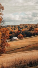 Poster - Vibrant autumn colors transform the landscape as rolling hills cradle a quaint house, surrounded by trees adorned with rich shades of orange and yellow.