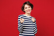 © ViDi Studio - Young smiling cheerful fun Caucasian happy woman she wear blue striped sweatshirt casual clothes point index finger camera on you isolated on plain red background studio portrait. Lifestyle concept.