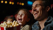 © standret - Father and children enjoying a movie at the cinema with popcorn