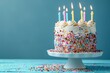 © darshika - Birthday cake  Birthday cake with colorful sprinkles and Candles over blue background