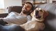 © Galib - A man is laying on a couch with his dog, both smiling.