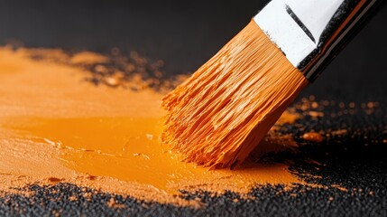 Aufkleber - A detailed close-up of a paintbrush is shown applying vibrant orange paint on a surface, capturing the dynamic and creative essence of artistic expression.