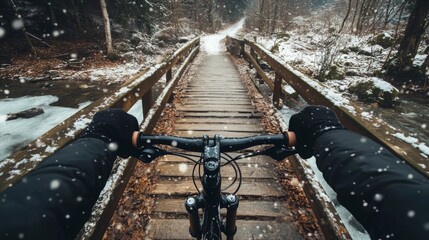 Aufkleber - From a point of view perspective, a bike ride on a snowy trail unfolds. The path leads over a wooden bridge surrounded by snow-dusted trees, creating a serene winter atmosphere.