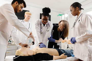 medical personnel demonstrating cpr on dummy