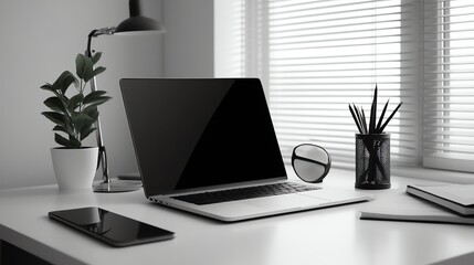 Poster - A laptop computer on a desk with a potted plant, a lamp, and a notebook.