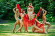 © Connect Images - A group of five dancers performs an outdoor routine in nature, draped in flowing red fabrics, USA