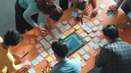 Top view of skilled programmer brainstorming idea about mobile phone interface while develop app development by using wireframe prototype. Web designer planning at table with sticky notes. Symposium.