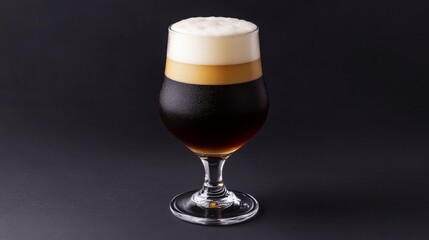 Poster - Elegant Glass of Dark Beer with Creamy Foam Against Black Background
