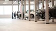 © Nattapol - Car repair crew working on vehicles in modern workshop environment