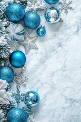 Sticker - Christmas decor theme. Overhead vertical shot of blue, white, and silver ornaments, snowflake and star decorations, and confetti on a white background with space for text.