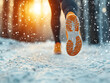 © photobuay - Runner on snowy path during sunrise, emphasizing winter running safety and determination